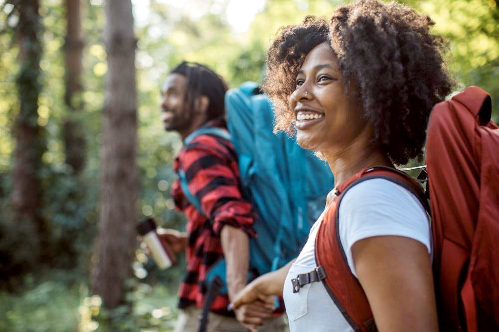 photo of a couple hiking in the wood