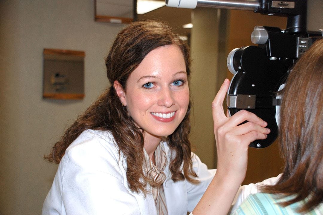 photo of Doctor Jessica Wentzell performing eye exam on a patient