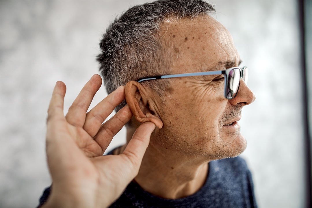 photo of a man checking his hearing of his ear