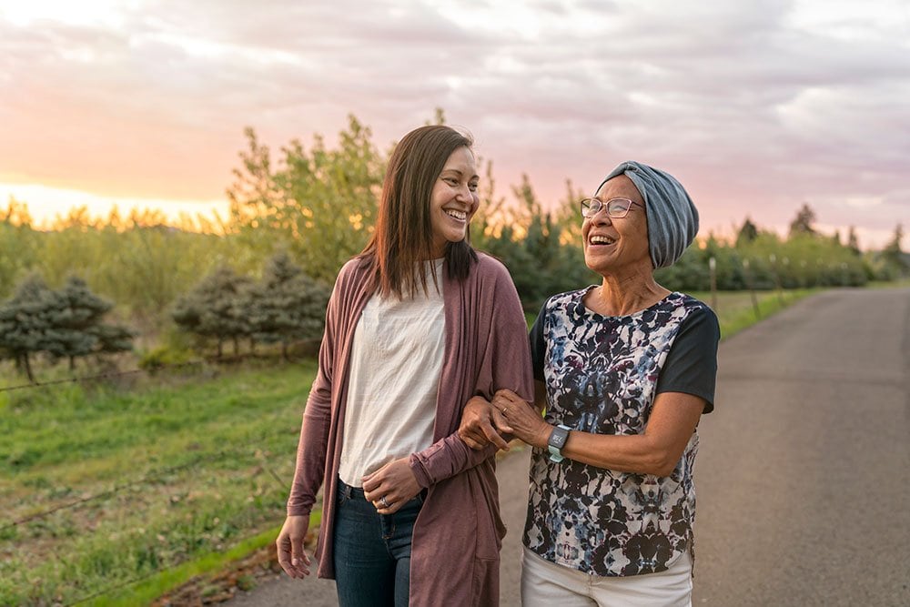 photo of 2 women walking outside