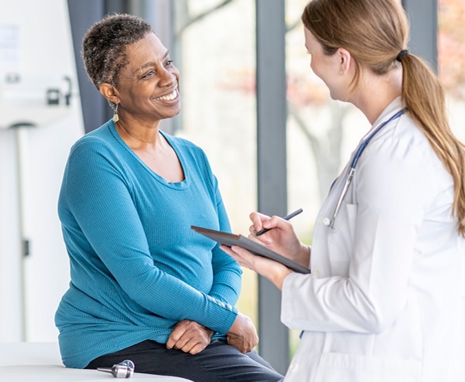 Woman talking to doctor