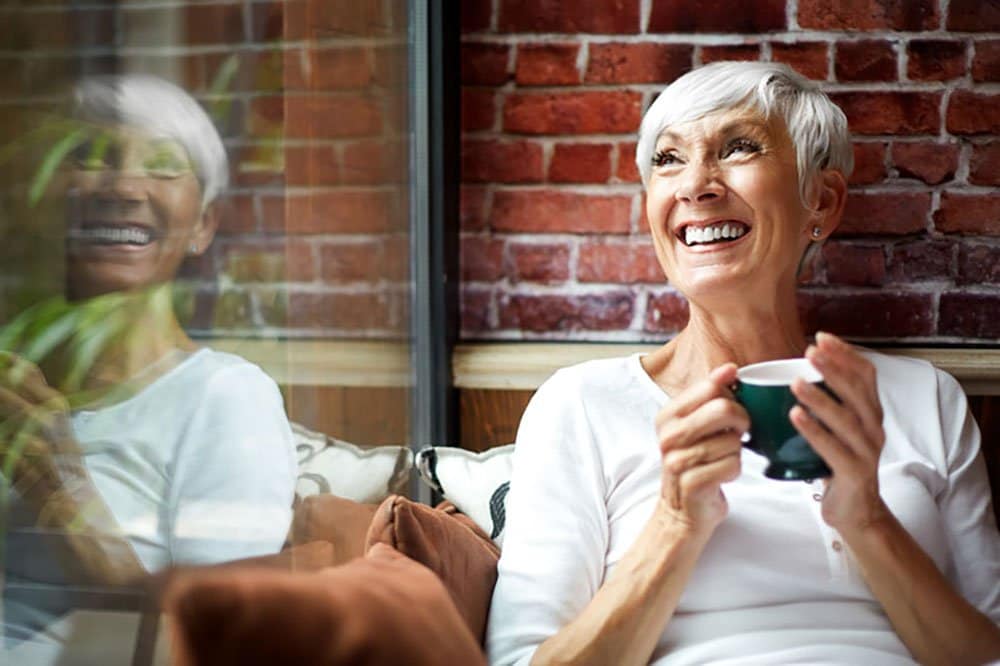 photo of a mature woman holding a mug in her hands