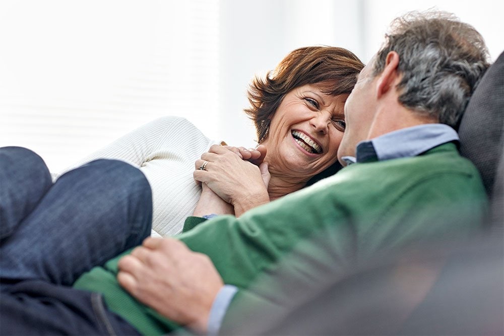 photo of a mature couple sitting on couch