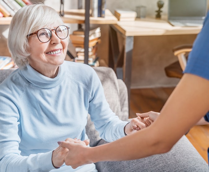 Older woman being helped to stand