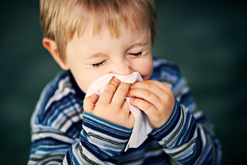 photo of a little boy sneezing