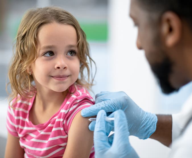 Young girl getting vaccinated