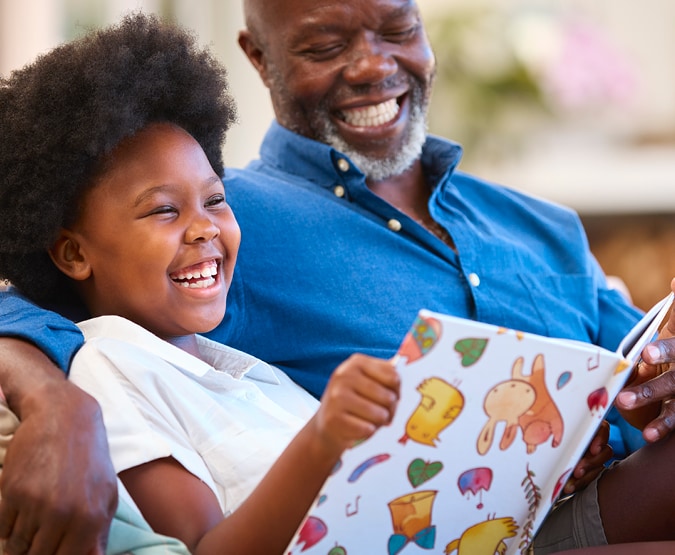 child and older man reading