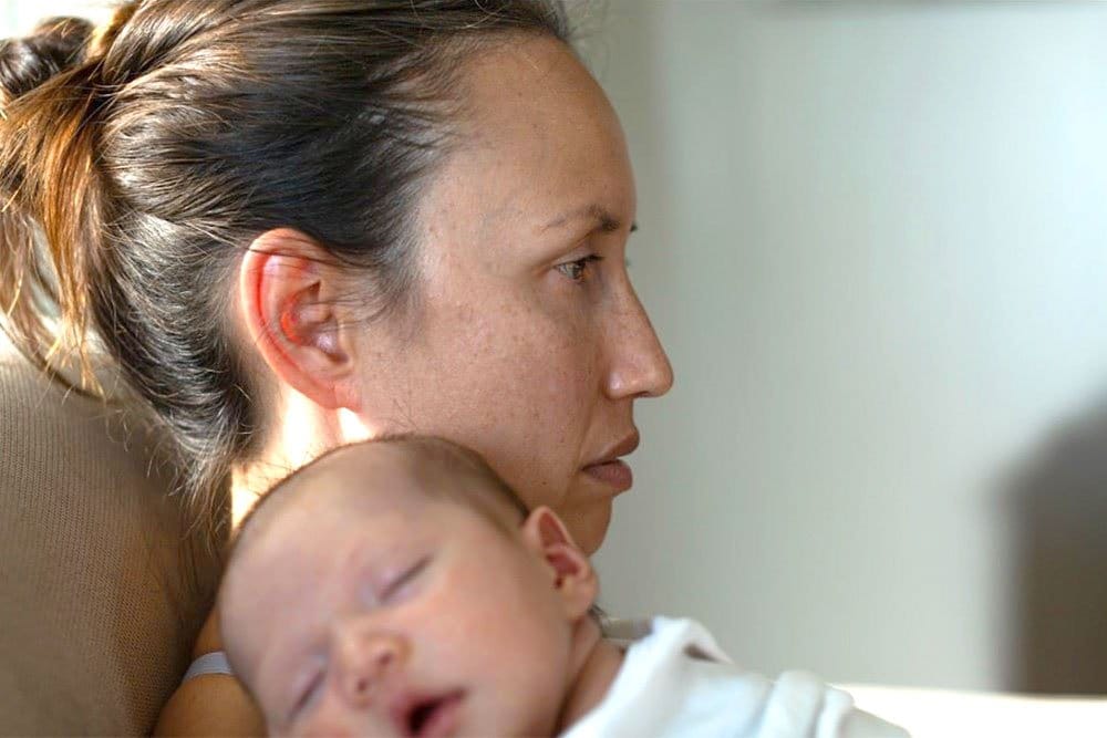 photo of a mom with depression holding her baby