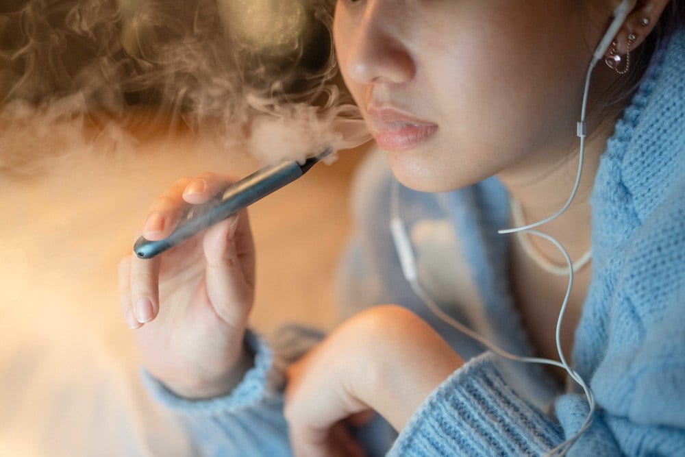 photo of a teen vaping