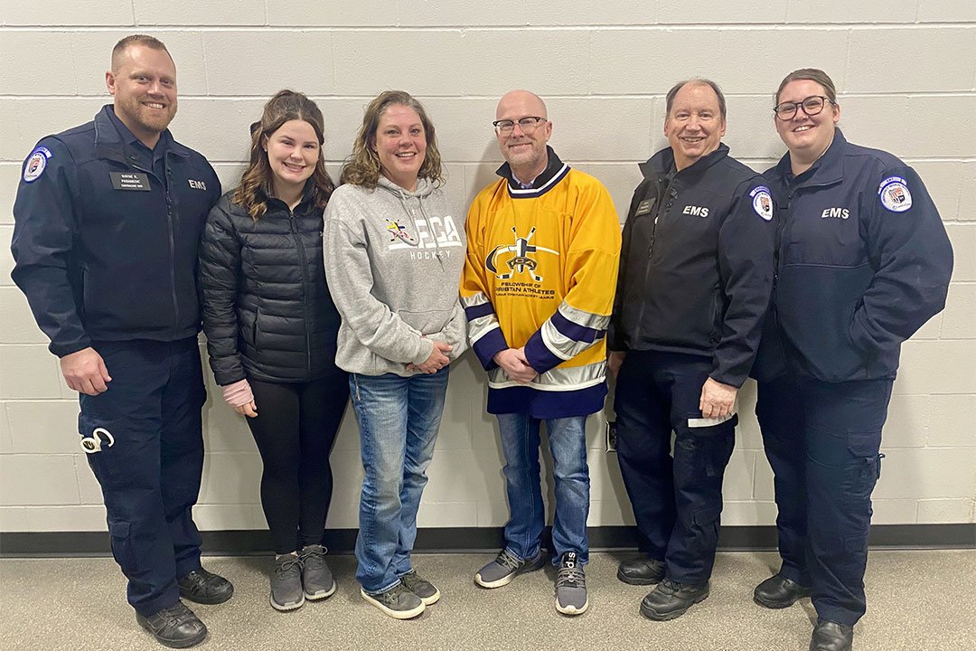 photo of Heather Hubel-Coleman with husband, daugther, Tim Rehn and the EMS crew