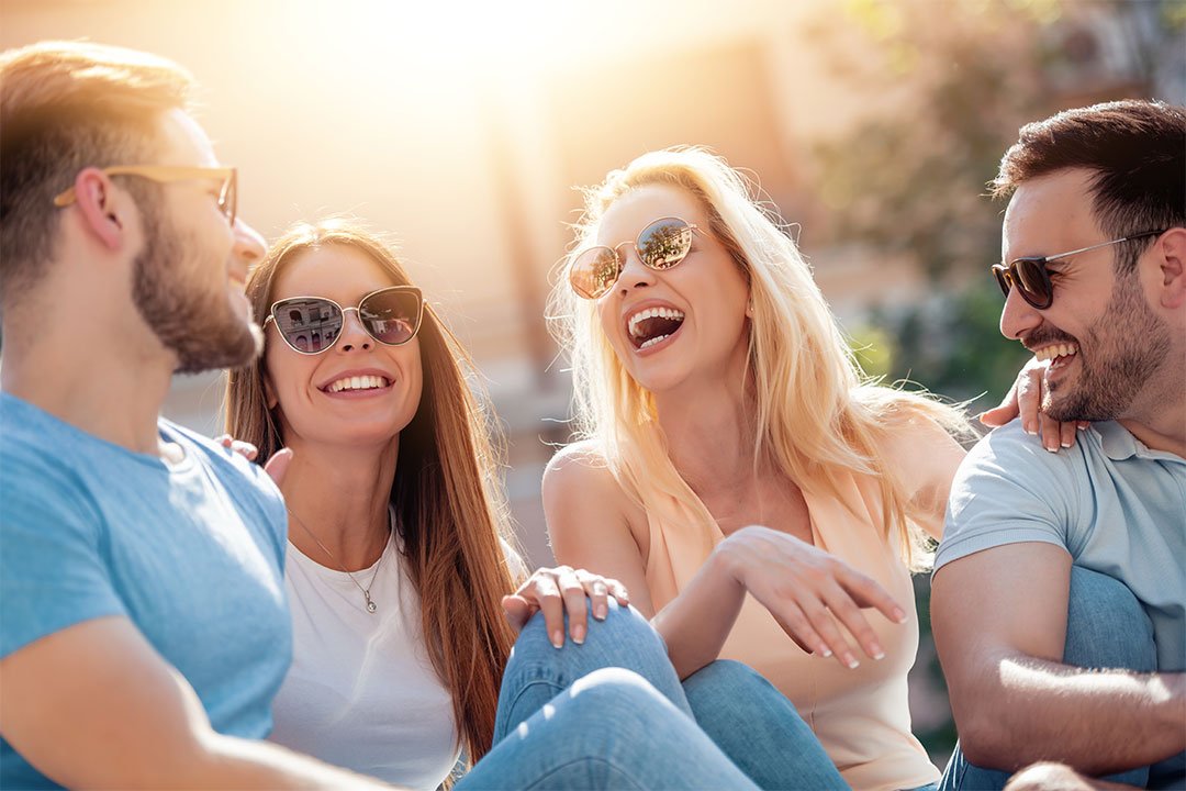 photo of 2 men and 2 women with sunglasses on