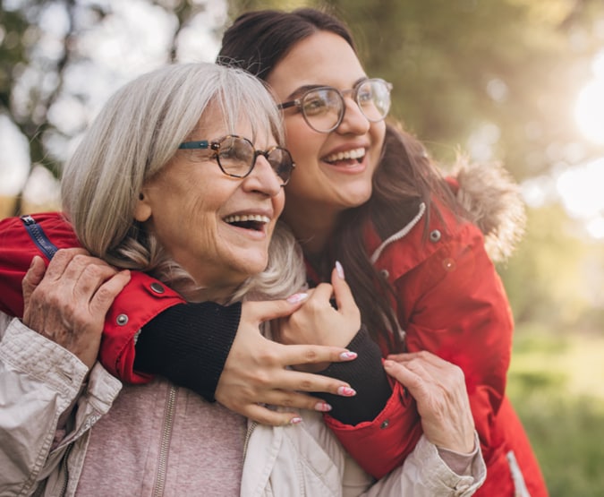 Older woman hugged by younger woman