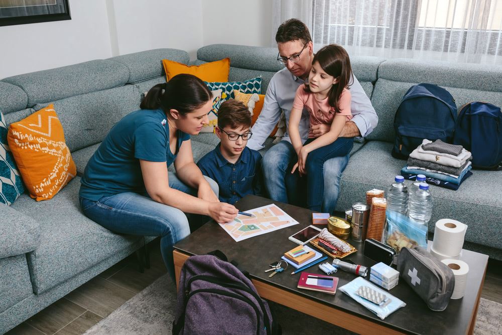 photo of a family in a living room with mom showing a printed floor plan