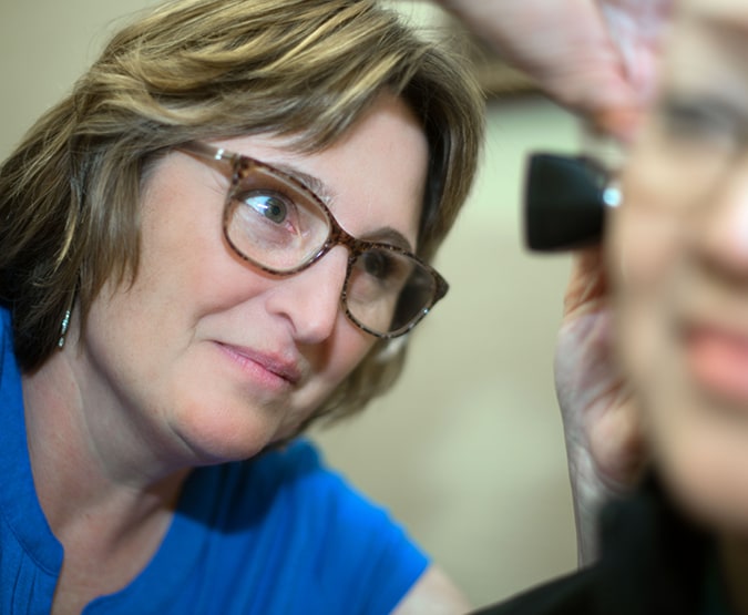 Physician looking a patient's ear