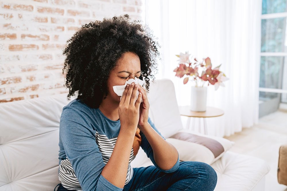 photo of a black woman sneezing