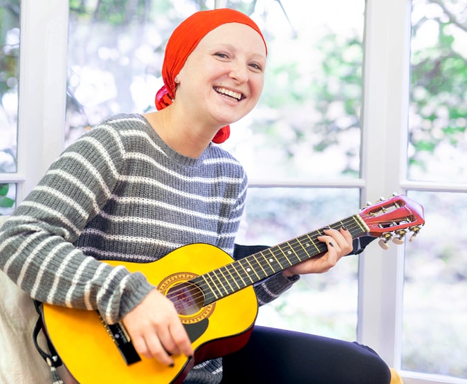 Cancer patient playing guitar