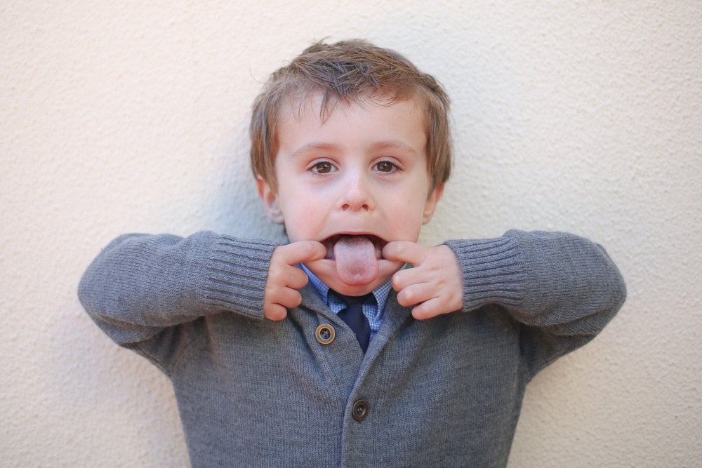 photo of a little boy with his tongue out