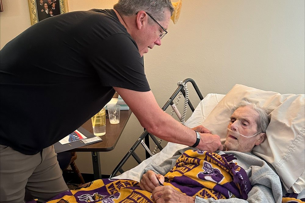 photo of Frank Kaufman receives a pin during a Veteran pinning ceremony, from his son, Bryan