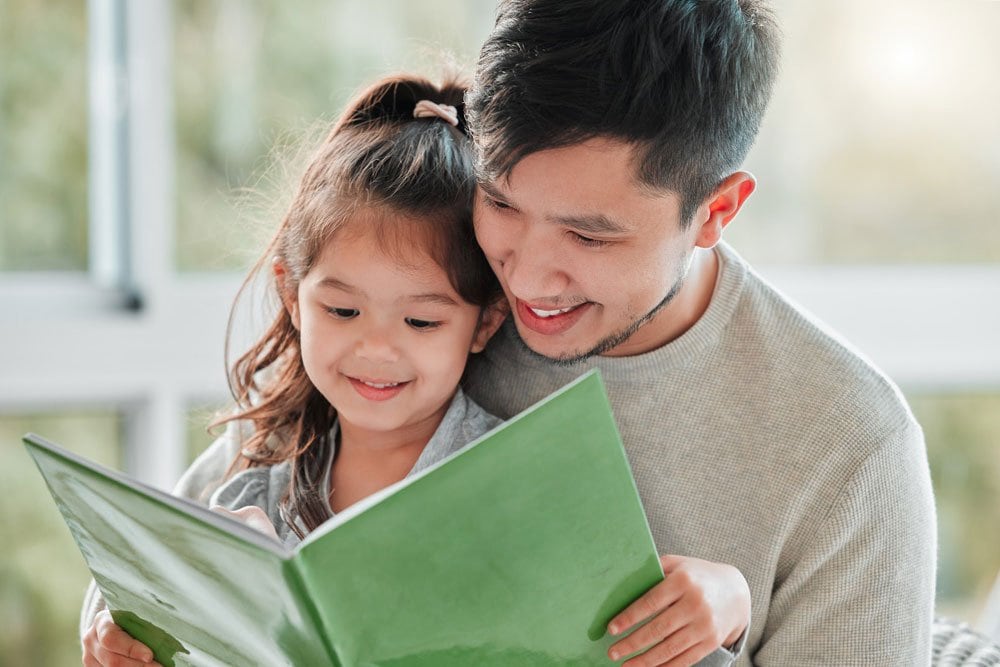 photo of a dad read with his little girl