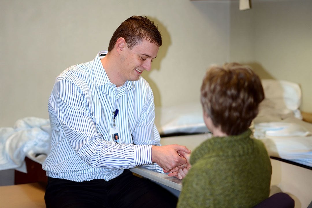 photo of occupation hand therapist, Brenne Gulden, examining a patient's hand