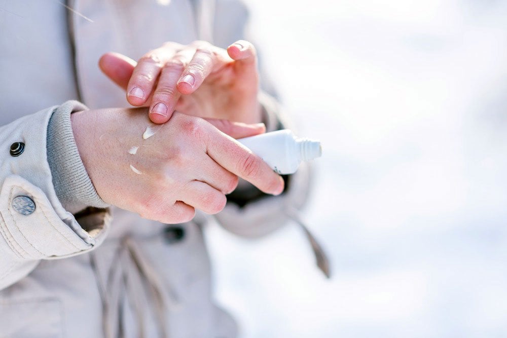 stock photo of someone applying lotion into it's hand